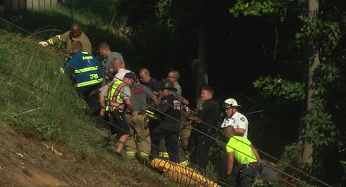 rescuers pull truck driver from crash